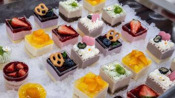 A variety of desserts arranged on a bed of ice.