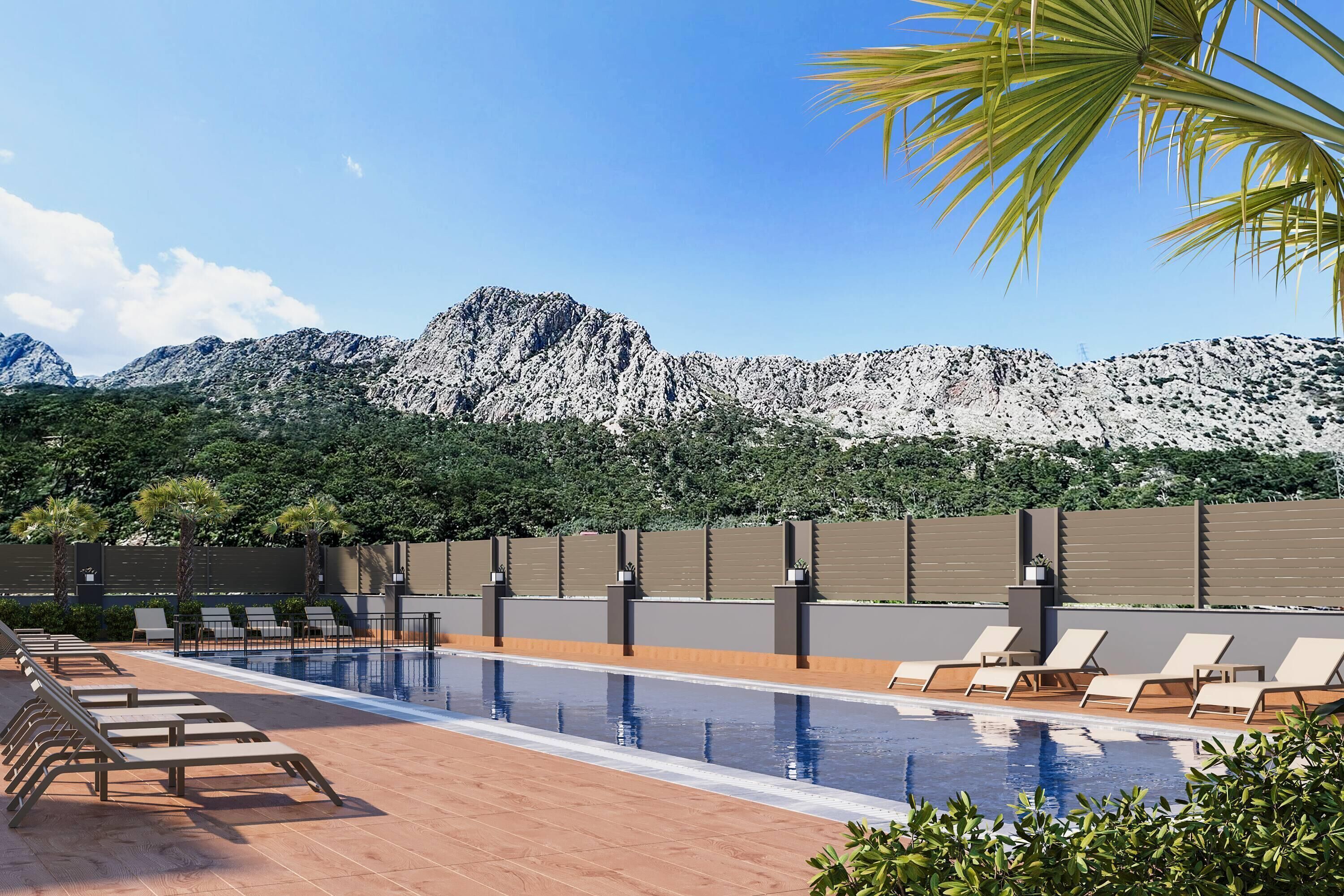 Une piscine avec des chaises longues, un paysage montagneux en toile de fond et une clôture moderne.