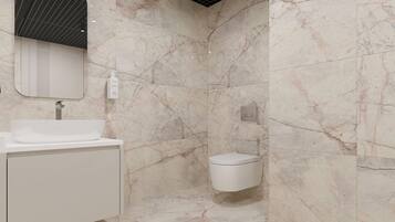 A bathroom with a marble wall, a sink, a toilet, and a mirror.