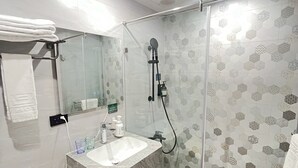 A modern bathroom with a glass-enclosed shower, a marble sink, and a visible hand dryer. - Tongcheng Fudelai Grand Hotel (Tainan)