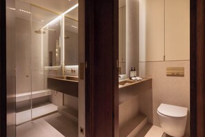A modern bathroom with a glass-enclosed shower, a vanity with a sink, and a toilet. - A Splendid 2-BR/2Ba w/ Services - Champs Elysées (Paris)