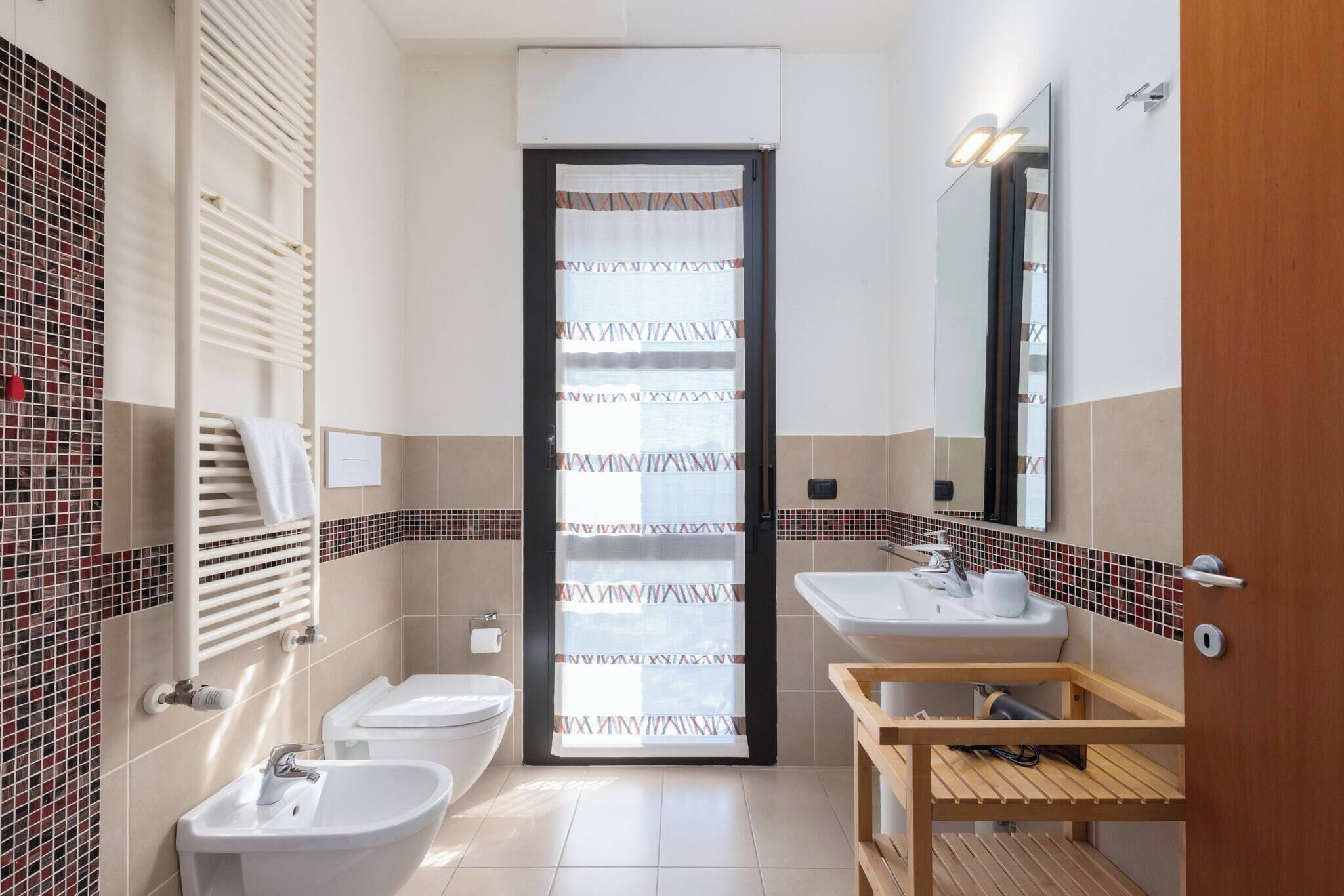 A bathroom with two sinks, a toilet, and a shower.