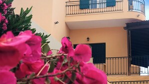 A two-story building with a balcony, a small window, and a door. - Escape to this Sea View Apartment close to Kalymnos Climbing Routes (KALYMNOS)