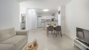 A modern living room with a sofa, a coffee table, and a TV. - Casa Valdebek With Pool (Pula)