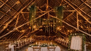 An indoor venue with a high, thatched roof, tables set for dining, and a menu board. - Moayana Liora Zanzibar · Pongwe · Beachfront - Authentic (Zanzibar)