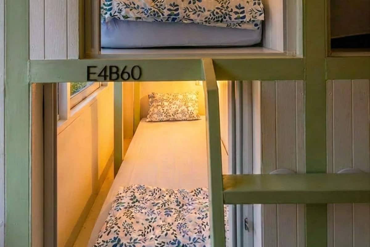 A bunk bed room with a number 'E4B60' on the lower bunk.