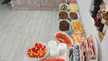 A buffet table with various food items and beverages.