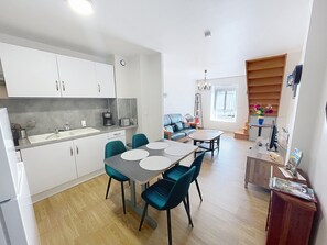 Eine moderne Wohnung mit Küche, Essbereich und Wohnzimmer.