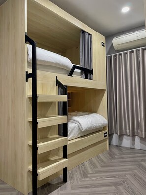 A bunk bed with a wooden frame, a pull-out desk, and a window with curtains. - SOULSTAY.BANGKOK (Bangkok)