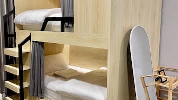 A bunk bed with a wooden finish, a small shelf, and a ladder.