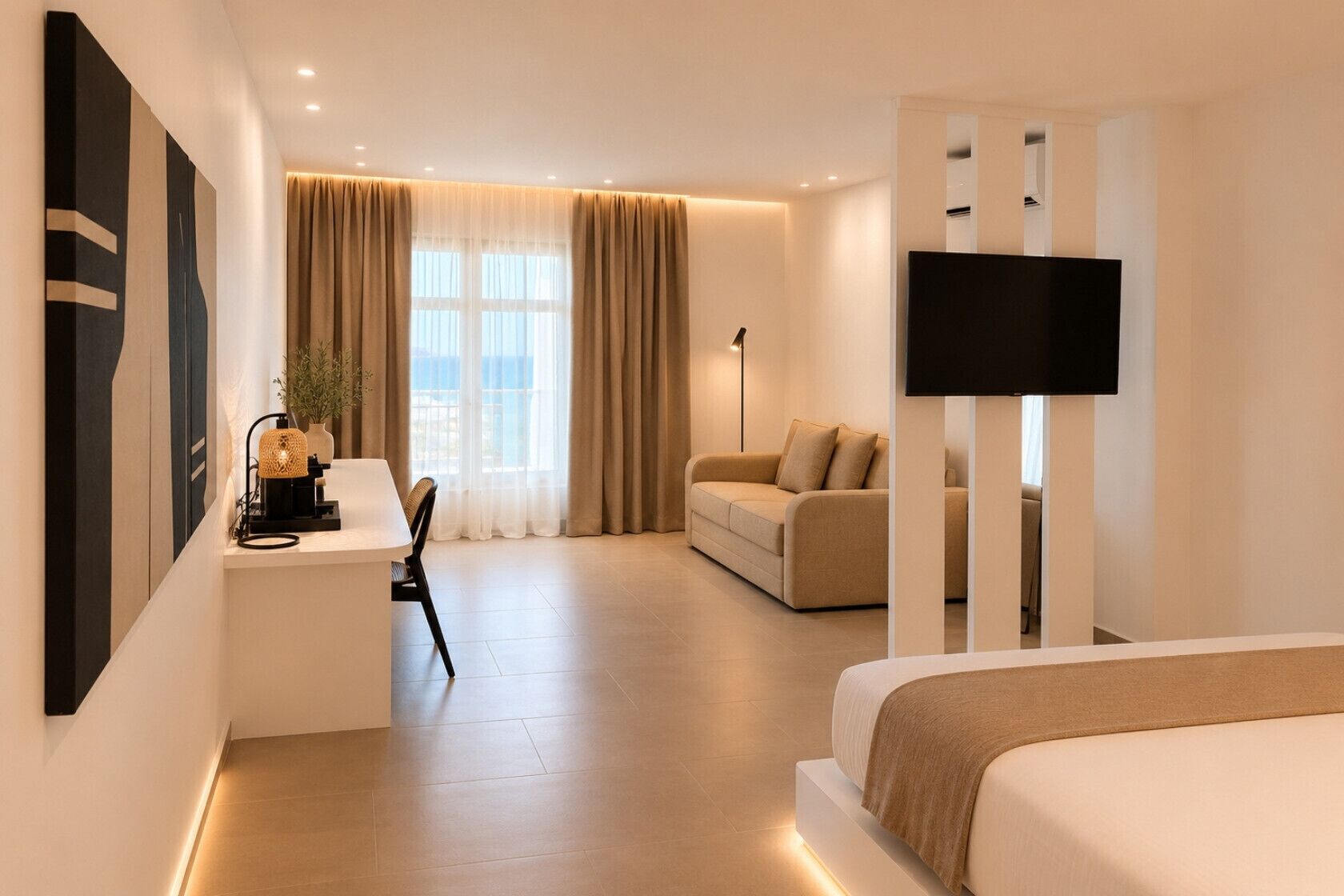 A hotel room with a bed, a sofa, a TV, a desk with a lamp, and a large window with curtains.