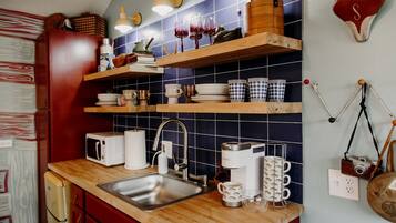 Fridge, microwave, coffee/tea maker, cookware/dishes/utensils