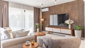 A modern living room with a sofa, armchairs, a coffee table, and a TV. - Villa Emocija Zadarvilas (Vrsi)