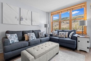 Unwind in this inviting living space with plush seating and stunning mountain vistas framing your view, perfect for cozy evenings after a day outdoors. - Steps to Gondola | Mountain Views, Cozy Fireplace & Hot Tubs (Keystone)