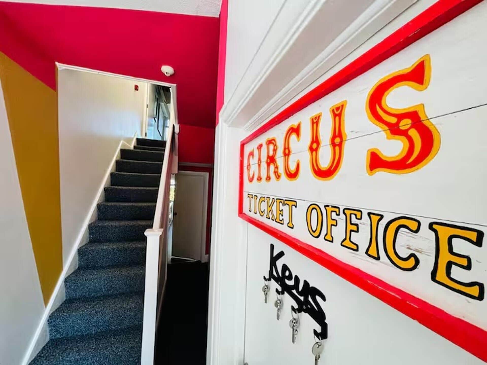 A staircase leading to a ticket office with a sign that reads 'CIRCUS TICKET OFFICE.'