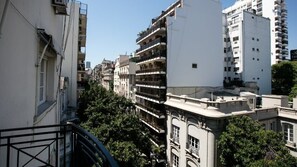 A multi-story building with balconies, a staircase, and trees in the foreground. - El Jacaranda Large 3 BR With Balcony in Recoleta (Buenos Aires)