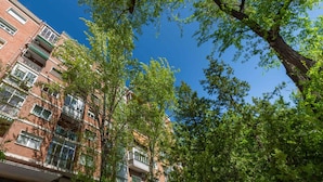 A multi-story building with balconies, surrounded by trees. - Republica 2BR apt Near Madrid s Financial Center (Madrid)