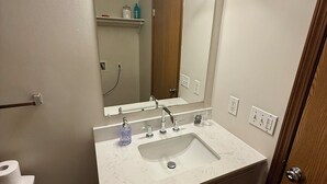 A bathroom with a sink, mirror, vanity, and a towel rack. - Find comfort in this cozy, recently updated apartment. Featuring two bedrooms, a full kitchen with oak cabinets, and a generous living space. It's designed for easy living with a ranch-style, step-up entry. Located in a peaceful neighborhood. (Marion)