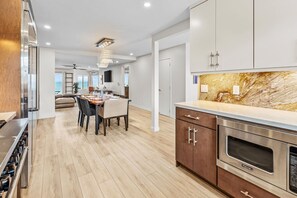 Open kitchen and dining area with plenty of room to gather. - Waterfront Home: Ocean Views, Pool & Hot Tub (Solana Beach)