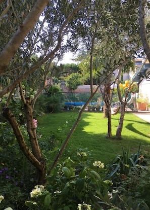 A garden with trees, a hammock, and a fence. - La Famille Maison Piscine Toulouse Centre (Toulouse)