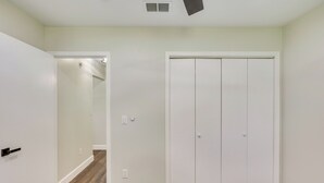 A hallway with a white door, a white closet, and a wooden floor. - Family Getaway w/ Fenced Yard in Orange Park! (Orange Park)