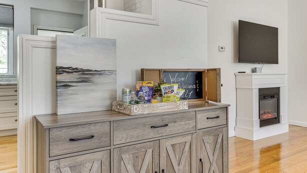 A modern living room with a fireplace, a flat-screen TV, and a decorative tray with snacks. - 4 Mi to Beach & Dtwn! Charming Fairfield Home (Fairfield)