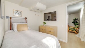 A bedroom with a bed, dresser, mirror, and a chair. - Walkable Home in Dtwn Caldwell! 1 Mi to Campus (Caldwell)