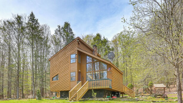 A wooden cabin with a balcony, a staircase, and a satellite dish. - Catskills Serenity! Cozy Vintage Cabin on 10 Acres (Grahamsville)