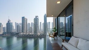 A balcony with a view of a city skyline and water. - Gala Guests - LIV Apartments Collection (Dubai)