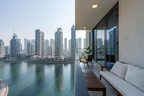 A balcony with a view of a city skyline and water. - Gala Guests - LIV Apartments Collection (Dubai)