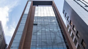 A high-rise building with a modern glass facade and brick detailing.