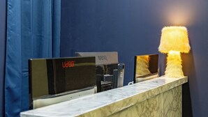 A reception desk with a digital display, a plush lamp, and a sign indicating a BenQ brand.