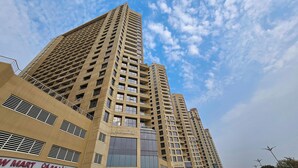 A high-rise building with multiple floors, large windows, and balconies. - Gala Guests - Lakeside Tower Living (Dubai)