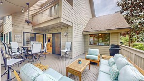 A covered outdoor area with seating, a table, and a view of the interior. - Significant Golf Views from this 3-Bedroom Fazio Villa (Hilton Head)