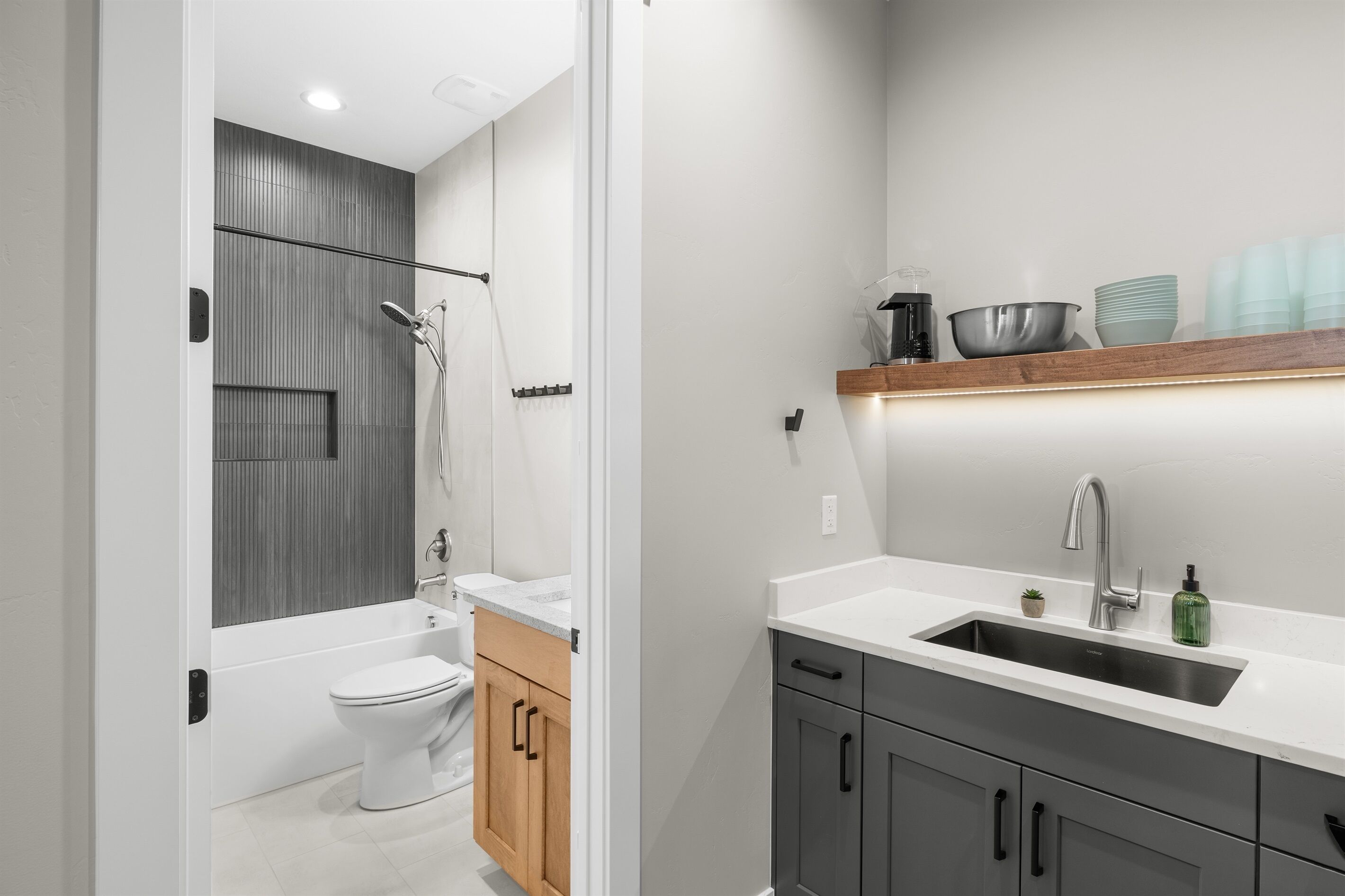 A modern bathroom with a bathtub, toilet, and sink.