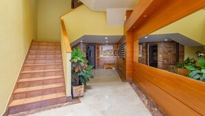 A hotel lobby with a staircase, a reception desk, and a fire extinguisher. - Vacation Apartment 'Veras Home' with Sea View, Wi-Fi and Air Conditioning (La Tejita)