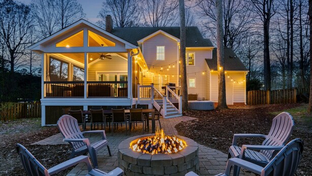 A house with a deck, outdoor seating, and a fire pit. - 3000sqft 5B3.5B Retreat Near Lenovo Center - Upscale 3 King Beds (Cary)