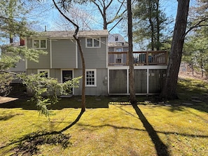 A two-story house with a fenced backyard, a deck, and a small tree. - Hickory Hill Hideaway! (Ogunquit)