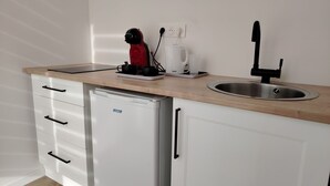 A compact kitchenette with a sink, a coffee maker, and a compact refrigerator. - NAUSICA (Saint-Jean-de-Monts)