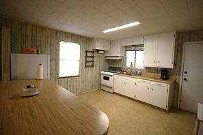 Una cocina con armarios de madera, una estufa y una encimera.