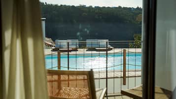 Deluxe Suite, Balcony, Pool View | Pool | Outdoor pool, pool umbrellas, pool loungers