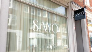 A window with the text 'SAYO BOUTIQUE HOTEL' and a sign above it. - SAYŌ Boutique Hotel (The Hague)