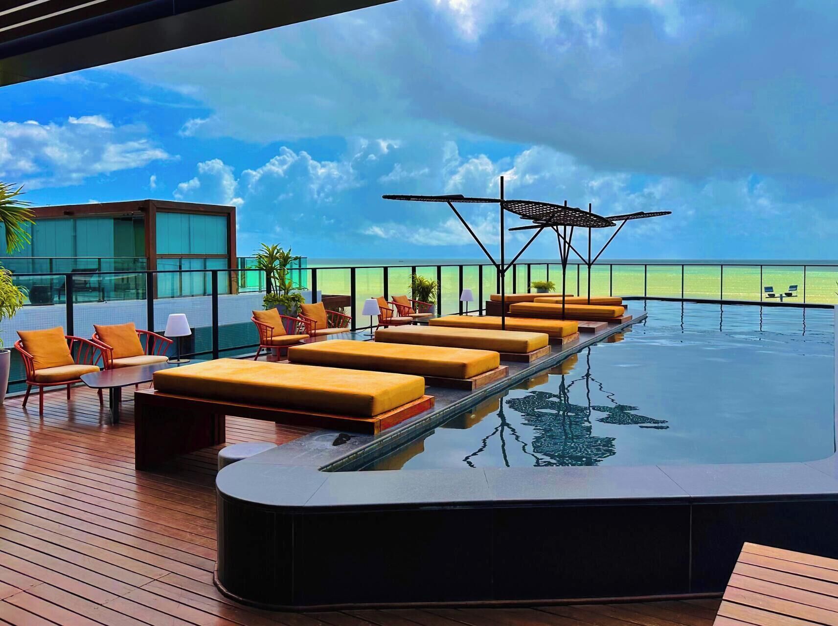 Outdoor pool, open 6:00 AM to 10:00 PM, pool umbrellas, sun loungers