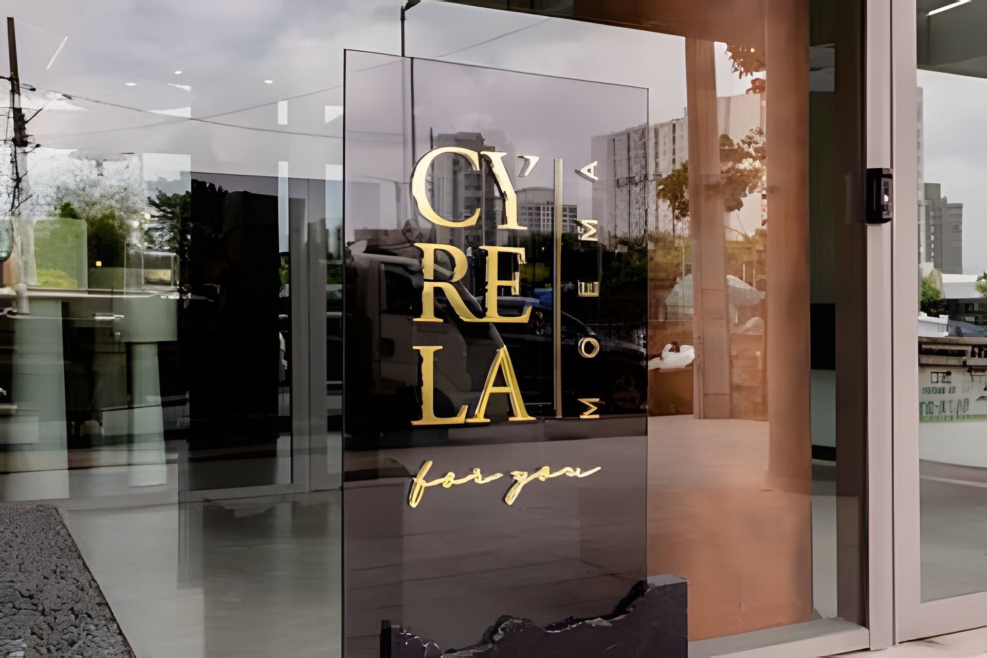 A glass facade with the text 'CYRELA' and 'for you' in gold lettering.