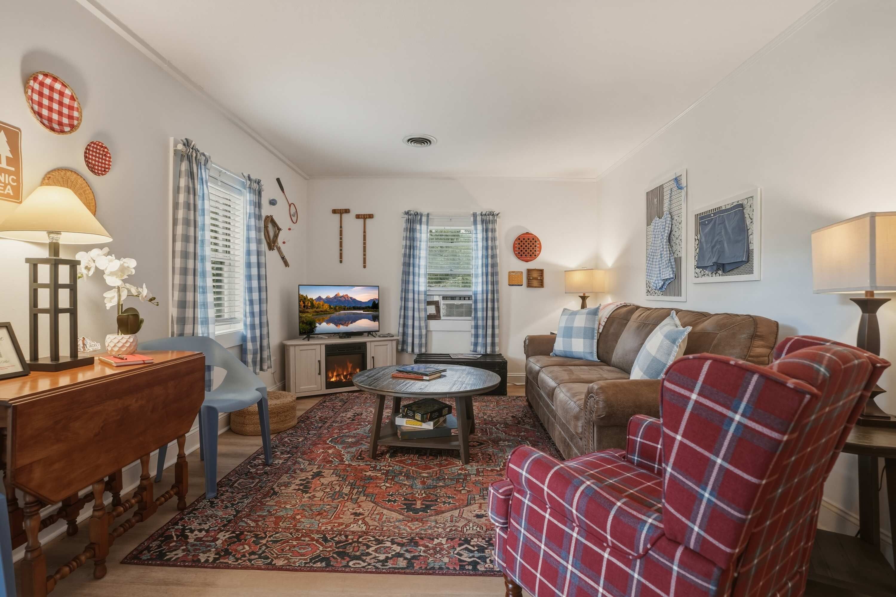 A cozy living room with a fireplace, a television, a sofa, and a coffee table.