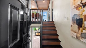 A staircase leading to a second floor with a view of the outdoors. - 2026 FIFA retreat Beach house w/hottub (Des Moines)