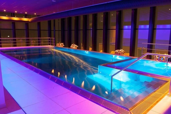 Swim under evening glow for a resort-like escape.