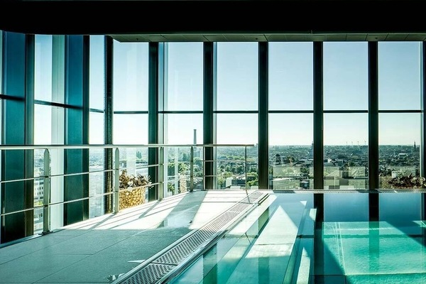 Unwind poolside as sunlight pours through floor-to-ceiling glass.