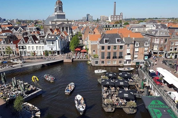 Sip and people-watch over bustling waterside terraces and boats.