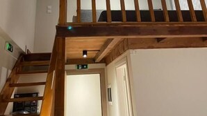 A wooden staircase with a handrail leading to a second floor. - Miltilon (Xylokastro-Evrostina)